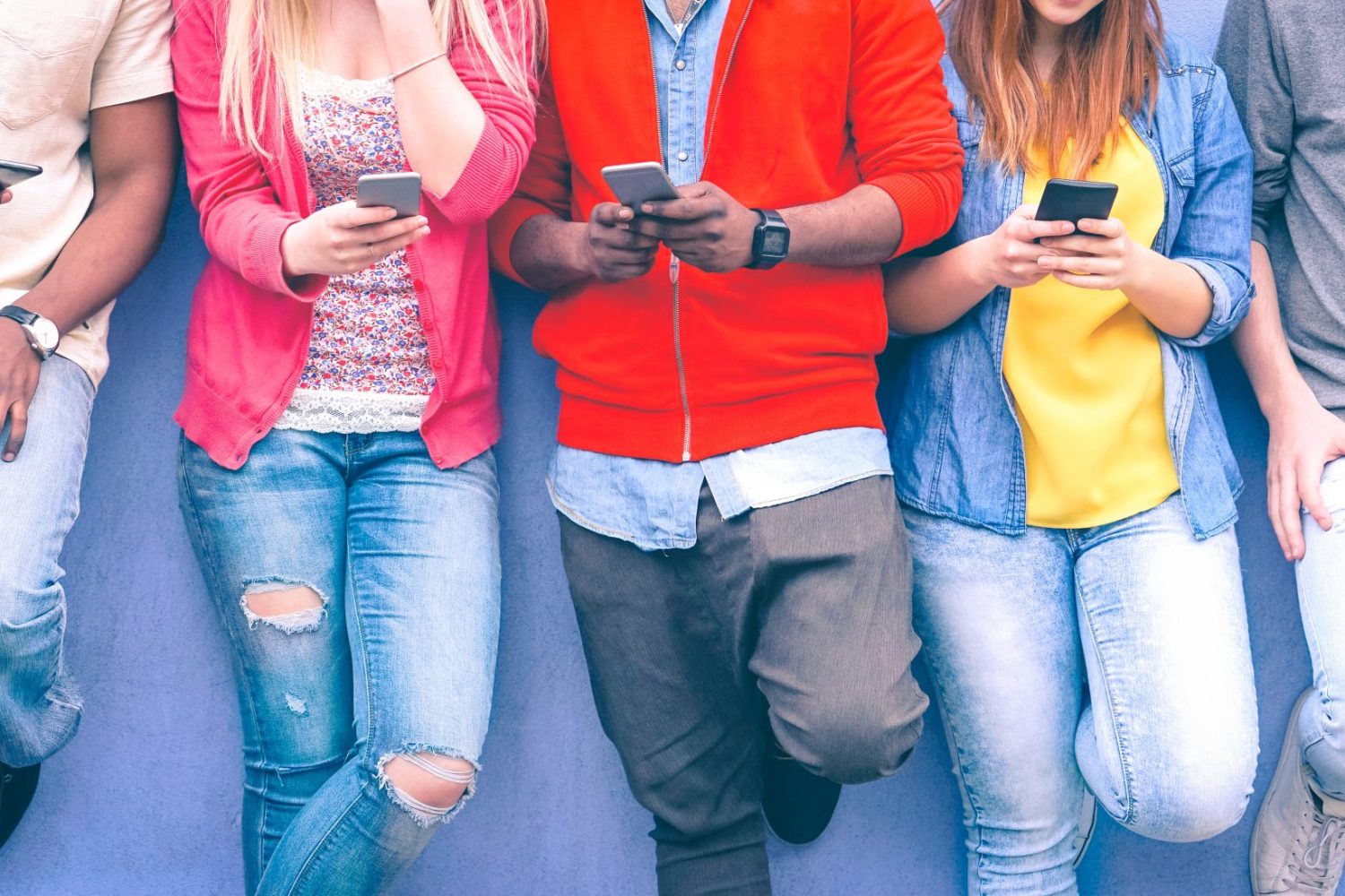 Teenagers,Texting,Mobile,Phone,Messages,Leaning,On,Urban,Wall,-